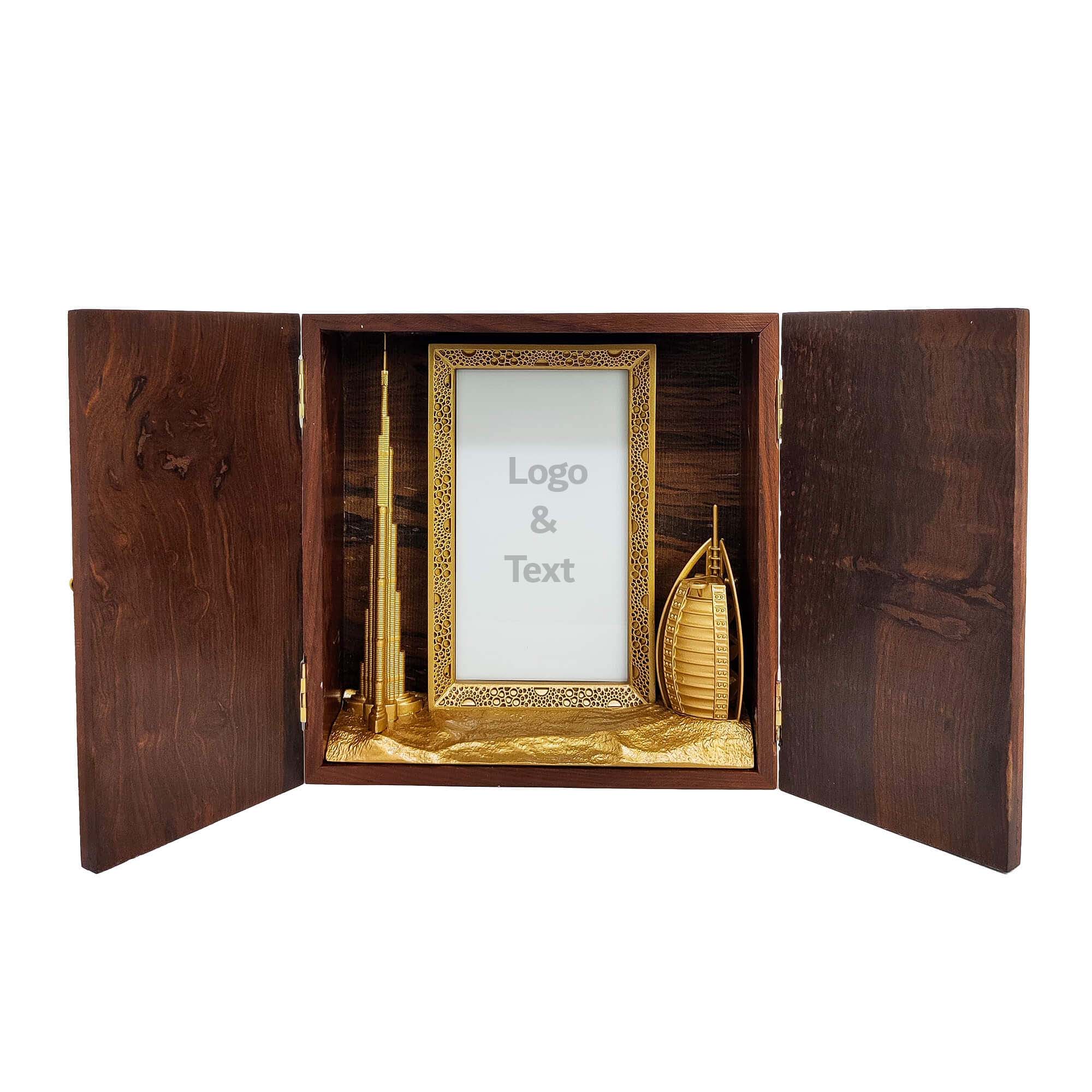 Wooden keepsake box featuring gold-finished 3D models of Burj Khalifa, Burj Al Arab, and Dubai Frame with customizable acrylic space.